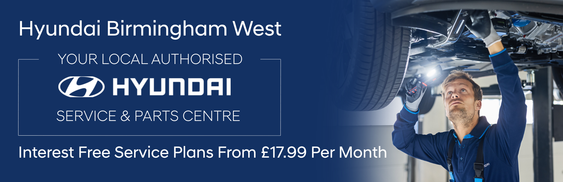 Worker inspects vehicle underside at Hyundai Birmingham West service centre.