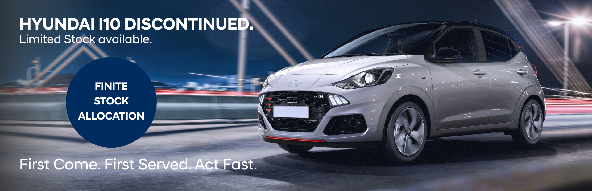 Silver Hyundai i10 car on road with text about discontinuation and limited stock.