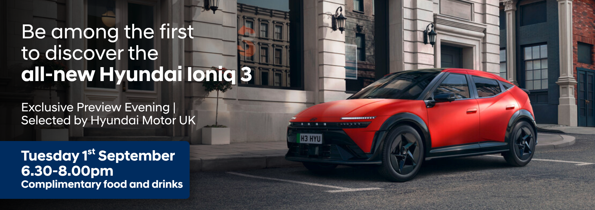 Red Hyundai Ioniq 3 parked beside a building with event details in white and blue text.